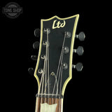 Guitar headstock with 'Ltd' branding on a black background, featuring the Tone Shop logo.