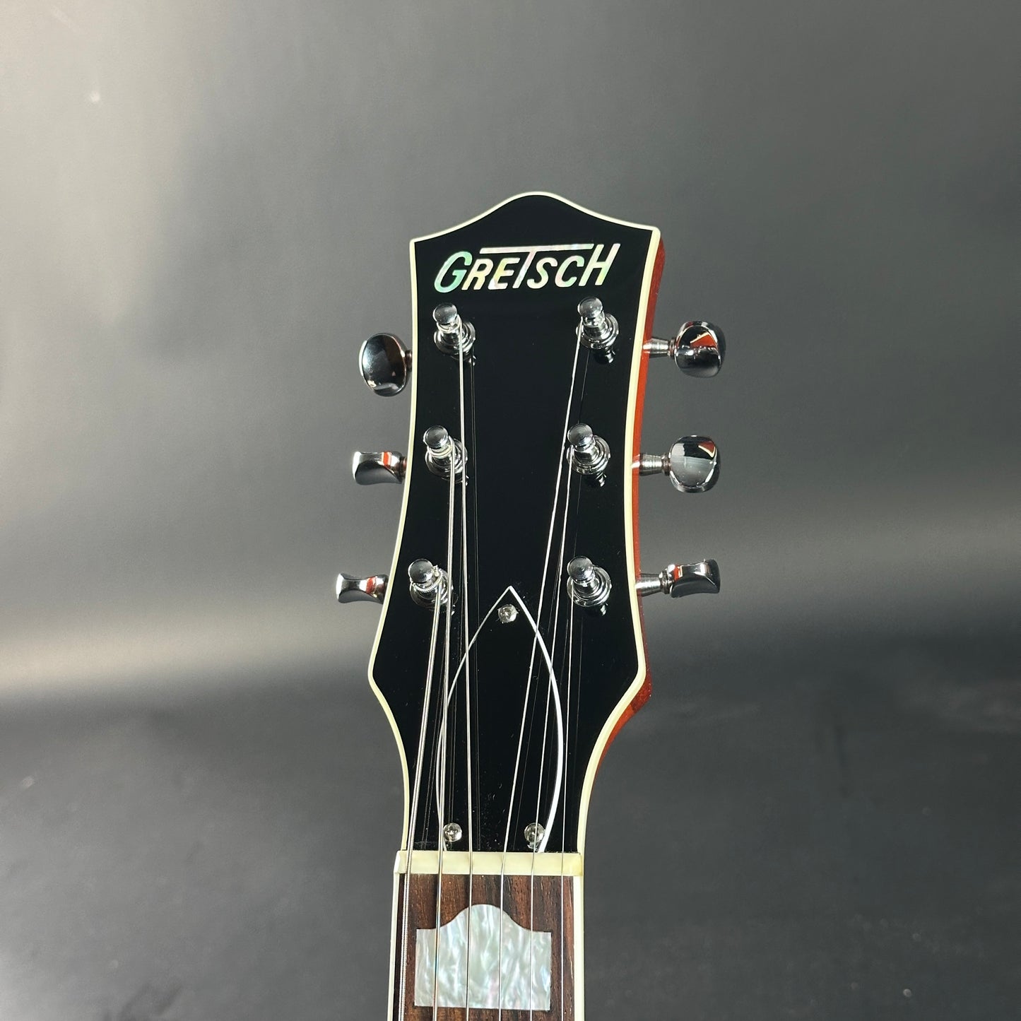 Gretsch guitar headstock on a dark background