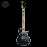 Black electric guitar on a white background with 'Tone Shop' logo.