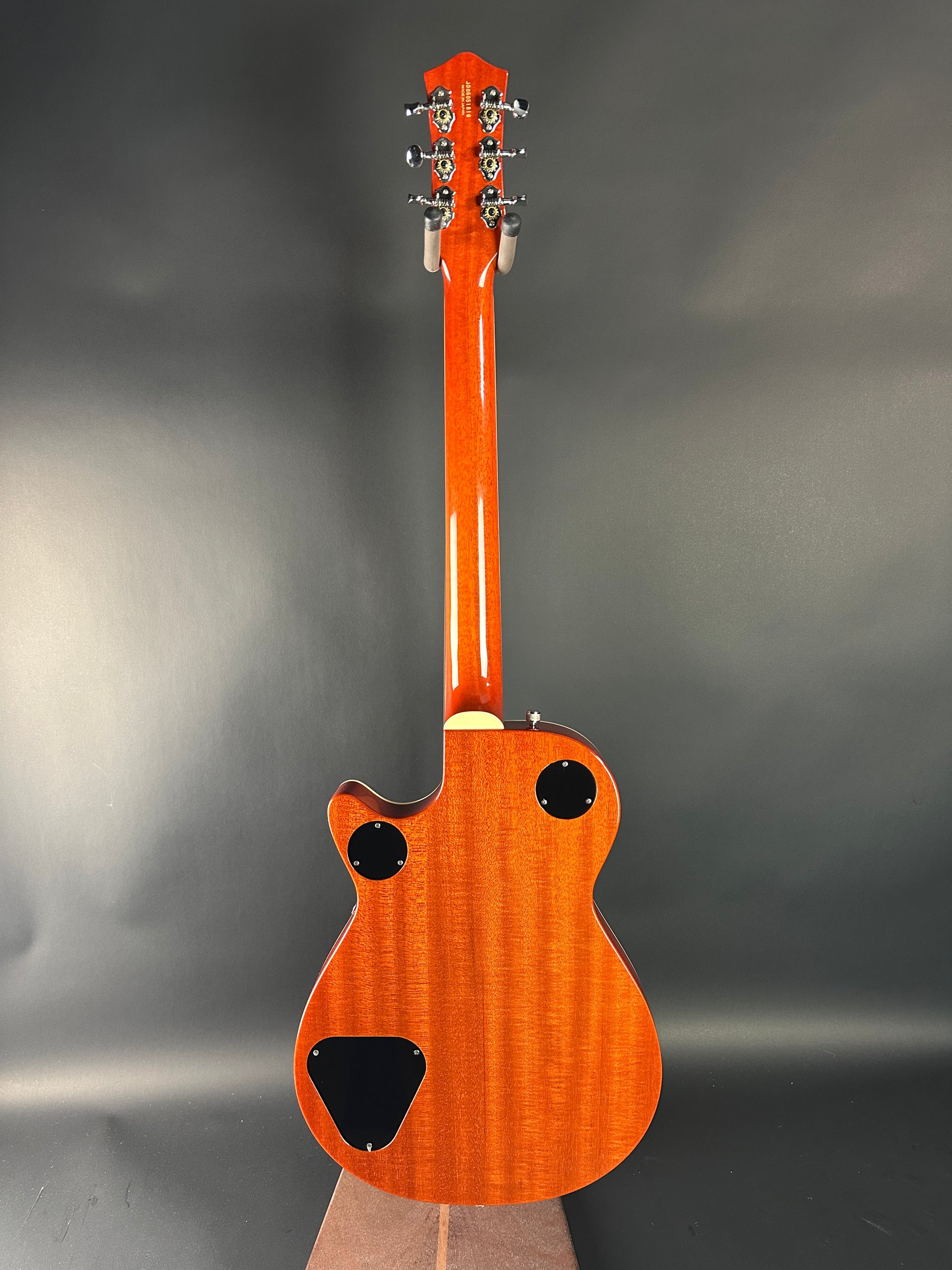 Wooden electric guitar on a gray background