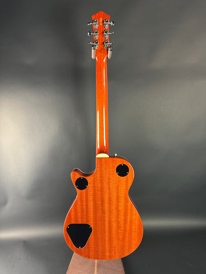 Wooden electric guitar on a gray background