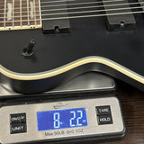 Guitar on a digital scale displaying weight