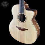 Acoustic guitar with a visible brand logo on a black background