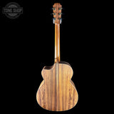 Wooden acoustic guitar on a black background with 'Tone Shop' logo.