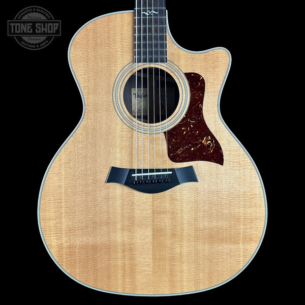 Acoustic guitar with a visible brand logo on a black background