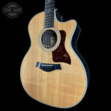 Acoustic guitar with a cutaway on a black background, featuring the Tone Shop logo.