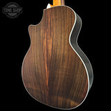 Wooden guitar body with a dark brown finish on a black background, featuring the Tone Shop logo.