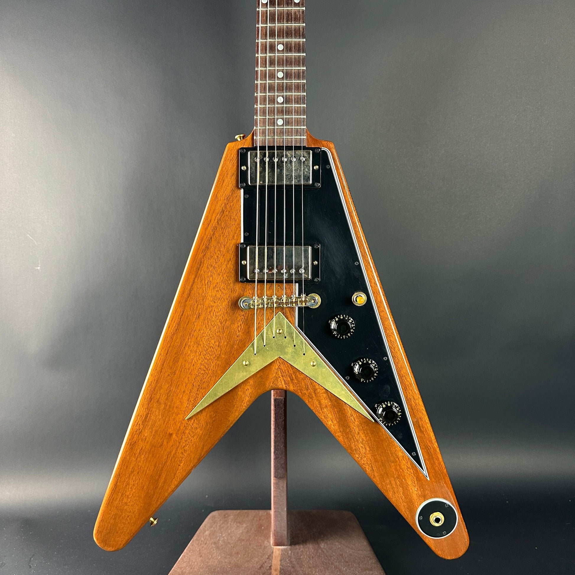 Wooden electric guitar with a unique design on a gray background