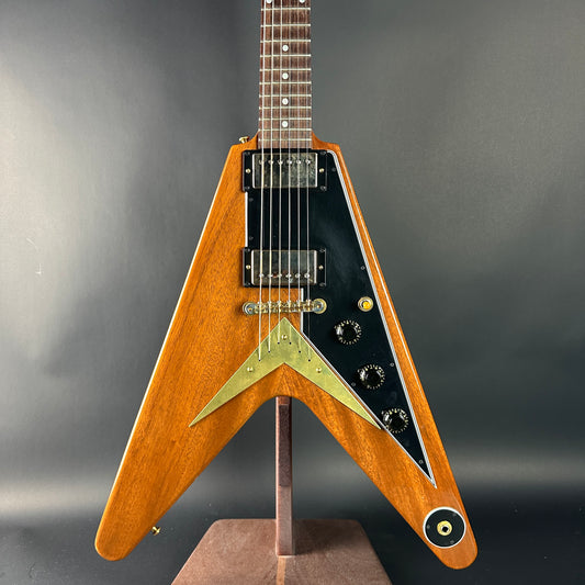 Wooden electric guitar with a unique design on a gray background