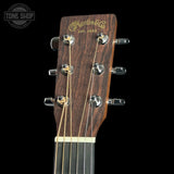 Guitar headstock with Martin & Co logo on a black background