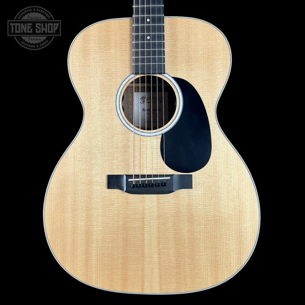 Acoustic guitar with a visible brand logo on a black background