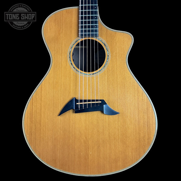 Acoustic guitar with a visible brand logo on a black background