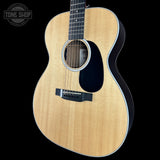 Acoustic guitar with a visible brand logo on a black background