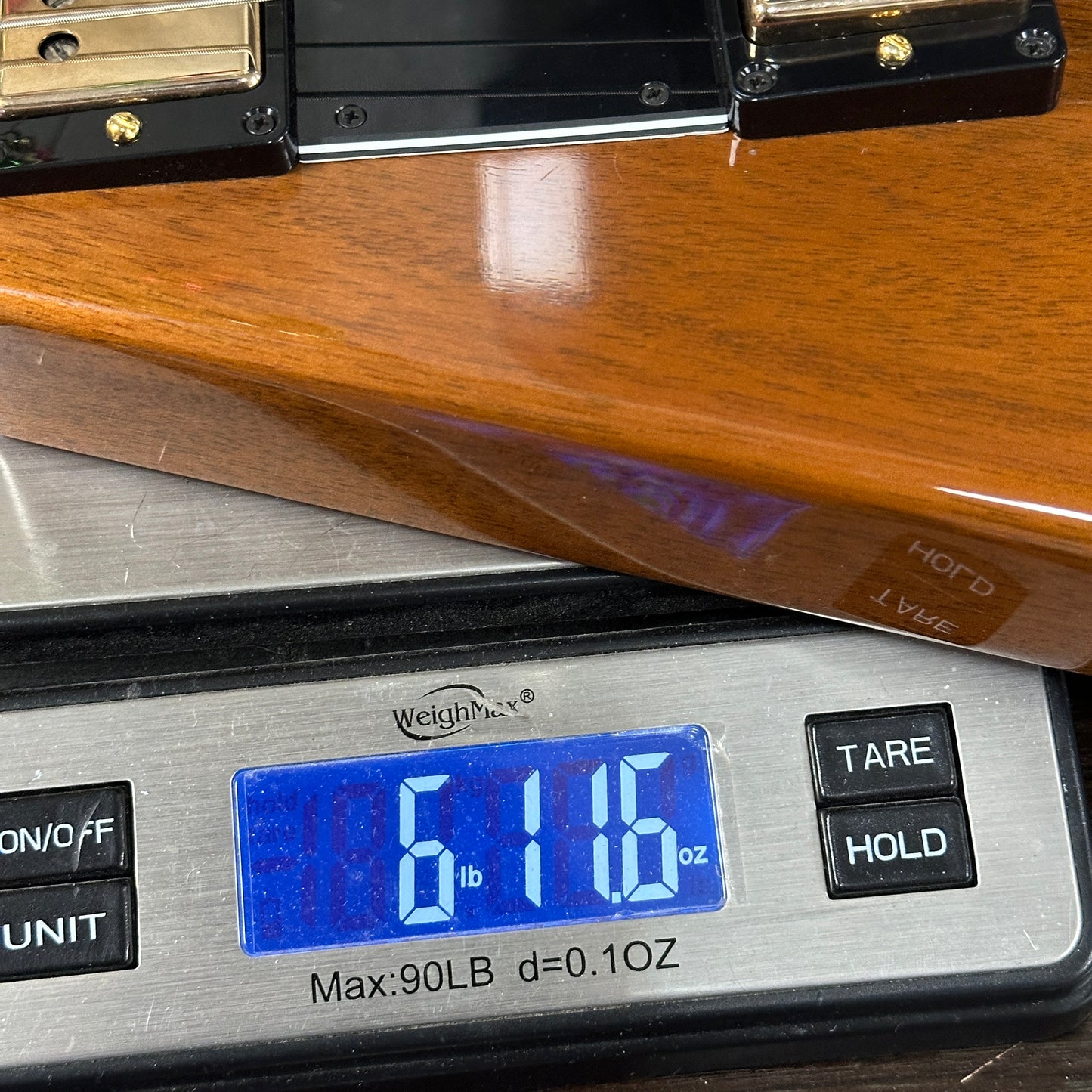 Digital scale displaying weight on a wooden surface