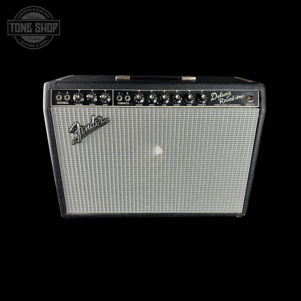 A Fender Deluxe Reverb 40 guitar amplifier with a black cabinet, silver grille, and black control panel, shown against a solid black background with a Tone Shop watermark in the top left corner.