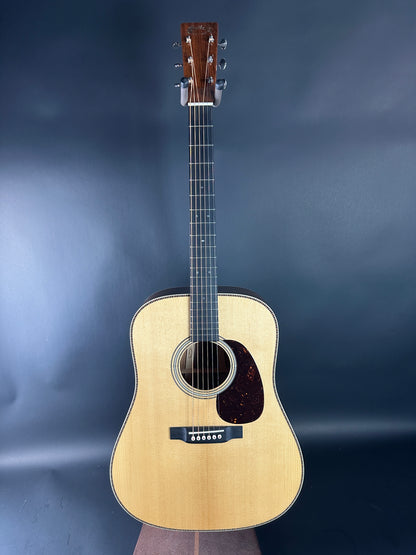 Acoustic guitar on a dark blue gradient background