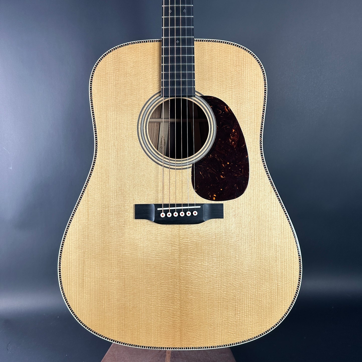 Acoustic guitar with a wooden finish on a dark background