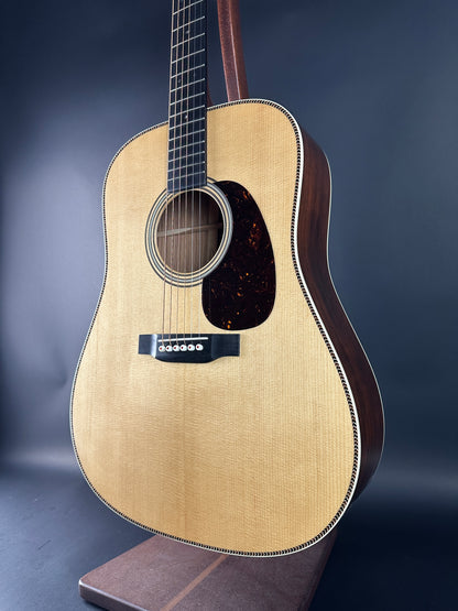 Acoustic guitar with a dark brown finish on a blue background