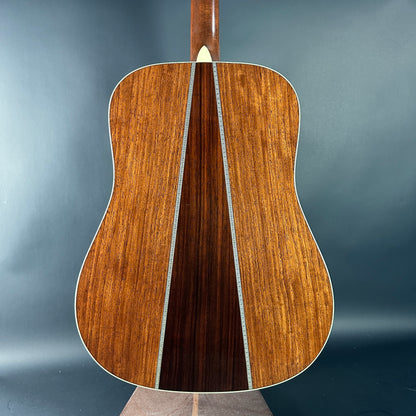 Wooden acoustic guitar on a gray background
