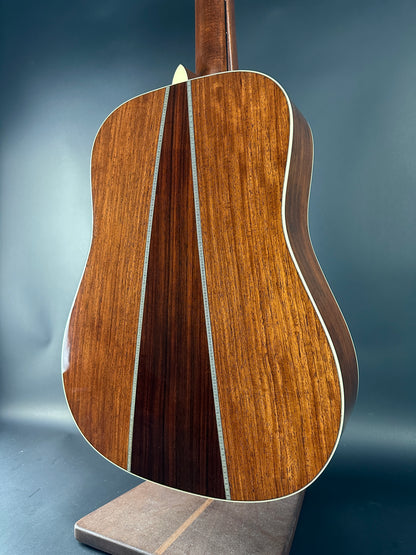 Close-up of a wooden acoustic guitar on a dark background