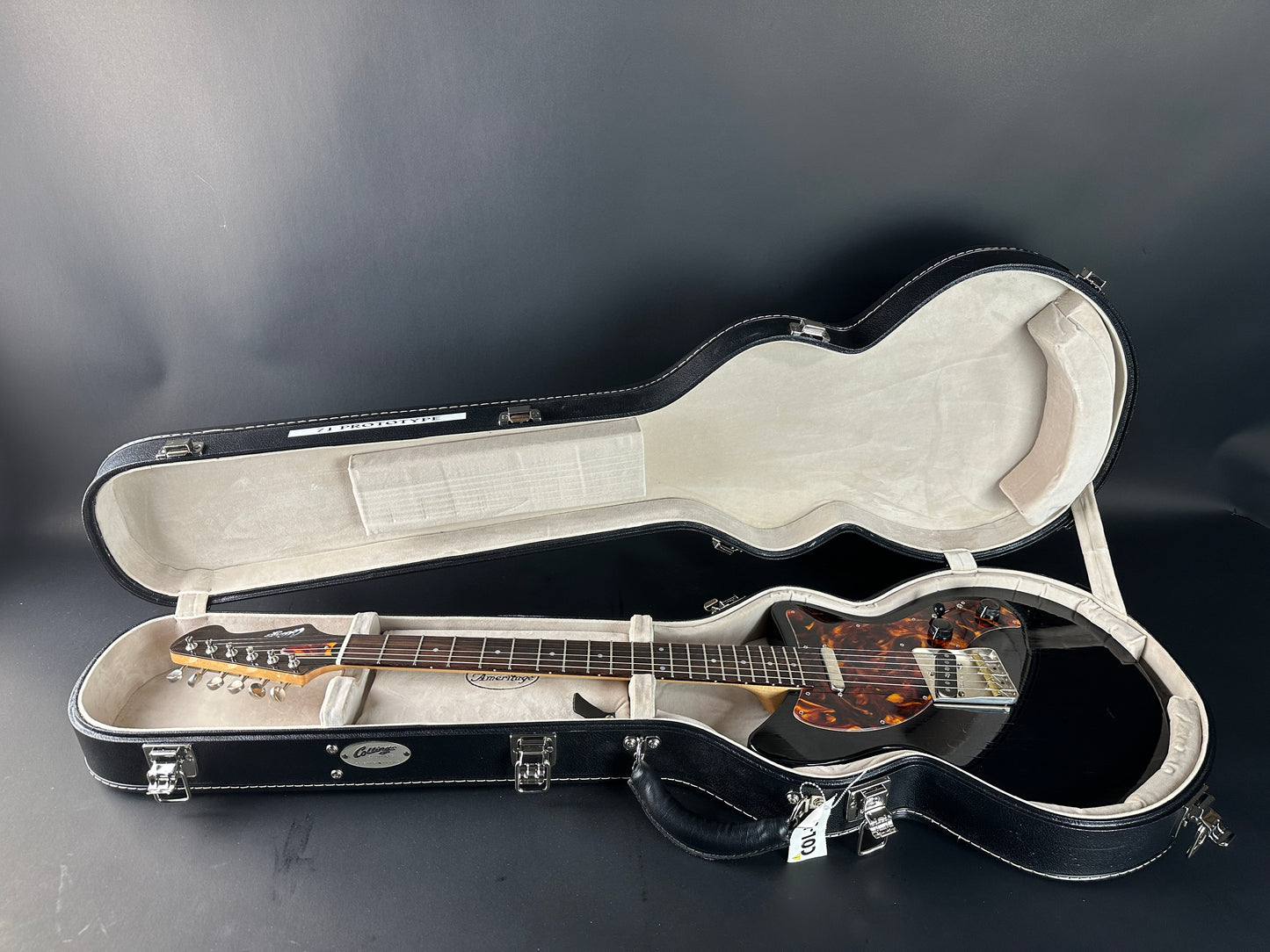 Guitar in an open case on a dark background