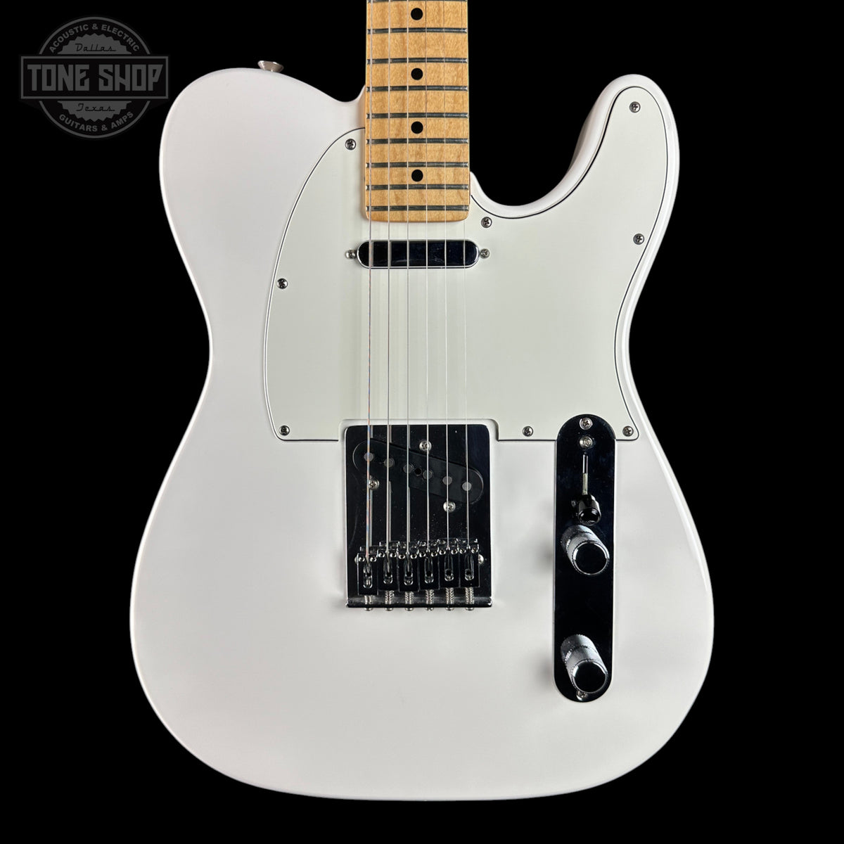 A white electric guitar with a maple neck, black hardware, and a black pickguard, shown against a solid black background with a Tone Shop watermark in the top-left corner.