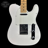 A white electric guitar with a maple neck, black hardware, and a black pickguard, shown against a solid black background with a Tone Shop watermark in the top-left corner.