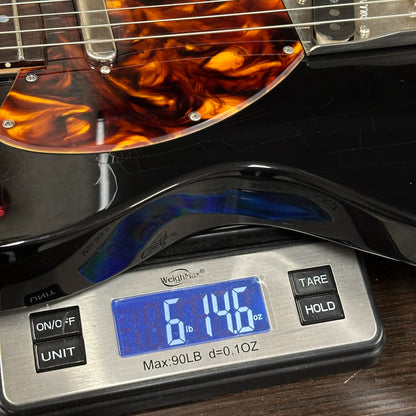 Guitar on a digital scale displaying weight