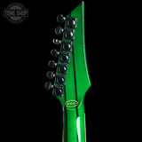 Close-up of the headstock of a green electric guitar against a black background, showing six black tuning pegs and a small oval green sticker with the text 'A101412'.