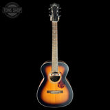 Acoustic guitar with a sunburst finish on a black background, featuring the 'Tone Shop' logo.
