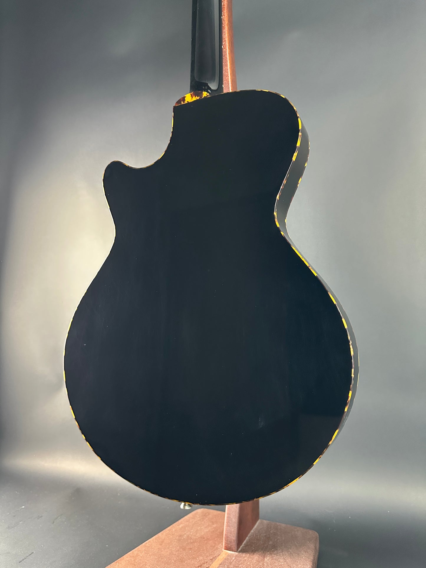 Close-up of a guitar's soundhole on a gray background