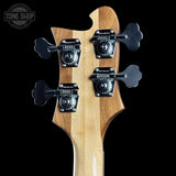Close-up of a guitar neck with tuning pegs on a black background, featuring the Tone Shop logo.