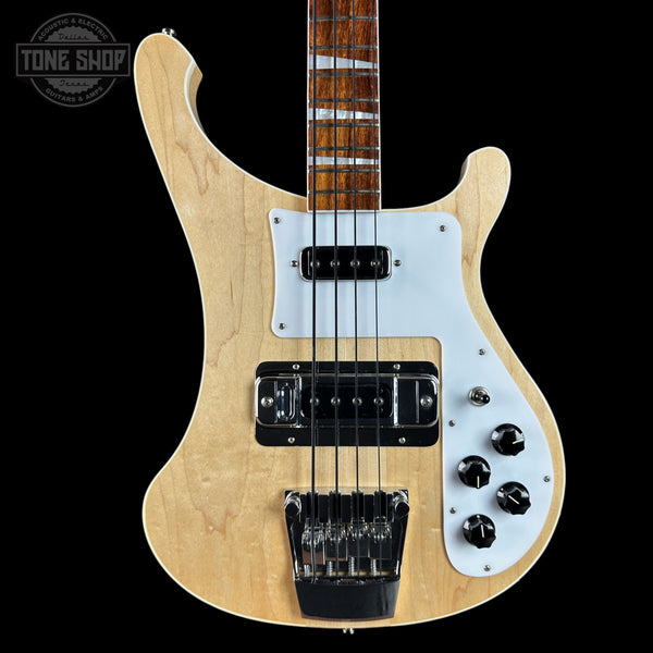 Electric bass guitar with a light wood finish and white pickguard on a black background.