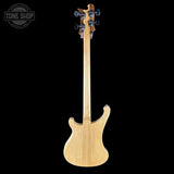 Back view of a bass guitar with a clear finish on a black background, featuring the Tone Shop logo.