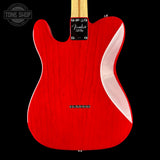 The back of a Fender Telecaster electric guitar in a vibrant red finish, featuring a maple neck and a white side stripe, shown against a solid black background.
