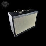 A black Fender amp head with a cream-colored front grille, shown at an angle against a solid black background. A Tone Shop watermark is visible in the top-left corner.