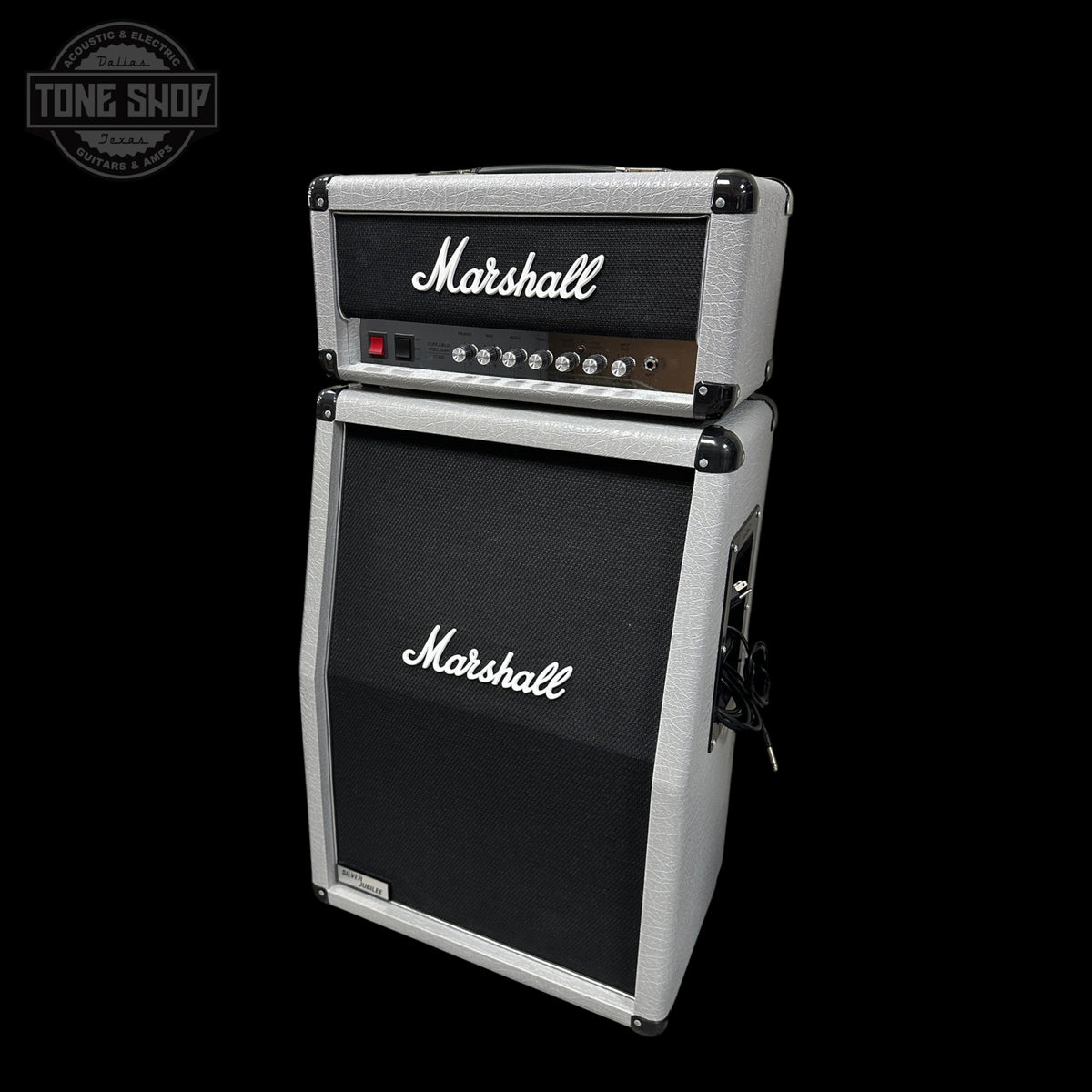 A Marshall guitar amplifier head and matching speaker cabinet stacked together, photographed on a solid black background. The cabinet has a black front grille with the white Marshall logo, and the head unit has a black front with white script branding, silver trim, and control knobs.