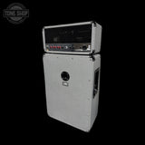 A stacked speaker amplifier cabinet with a silver textured metal body, black front grille, and black side handle, shown on a solid black background. A Tone Shop watermark is visible in the top-left corner.