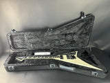 Guitar in a hard-shell case on a gray background