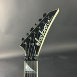 Jackson guitar headstock on a gray background