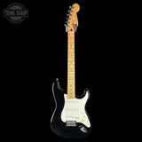 A black electric guitar with a natural maple neck and headstock, shown against a solid black background. A Tone Shop watermark is visible in the top-left corner.