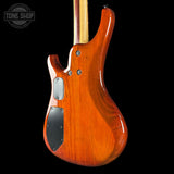 Wooden electric guitar body with a visible brand logo in the corner.