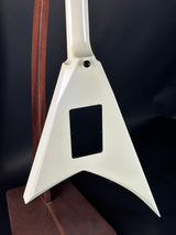 Guitar with a unique headstock design on a dark background