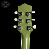 Green guitar headstock with tuning pegs on a black background, featuring 'Tone Shop' logo.