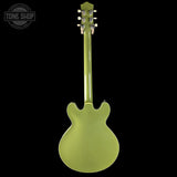 Green electric guitar on a black background with 'Tone Shop' logo.