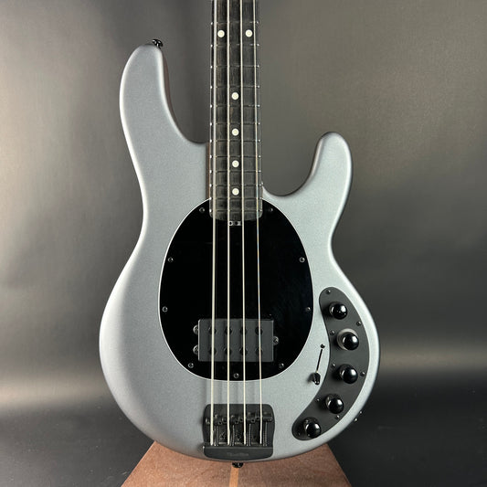 Silver electric bass guitar on a gray background