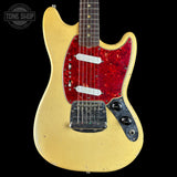 A Fender Stratocaster electric guitar with a yellow body, red glitter pickguard, and black control plate, shown against a black background with a Tone Shop watermark in the top left corner.