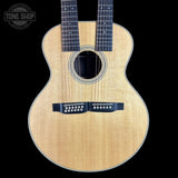 Acoustic guitar with a visible brand logo on a black background