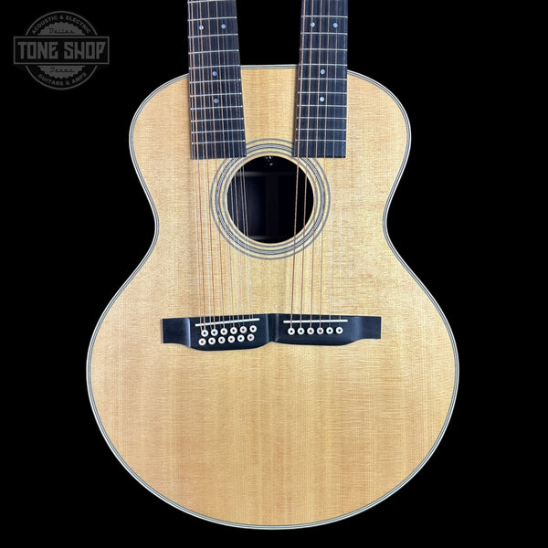 Acoustic guitar with a visible brand logo on a black background