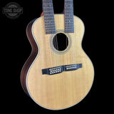 Acoustic guitar with 12 strings on a black background, featuring the Tone Shop logo.